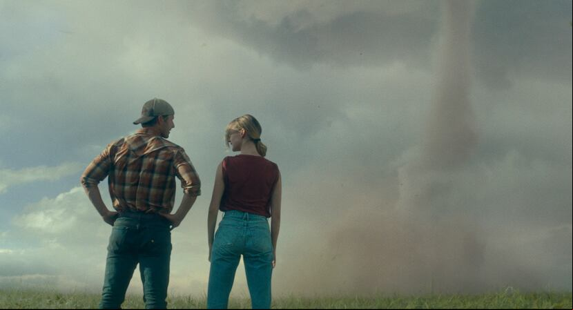This image released by Universal Pictures shows Glen Powell, left, and Daisy Edgar-Jones in a scene from "Twisters." (Universal Pictures via AP)